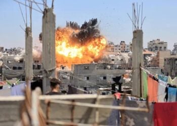 An explosion rises over a densely populated area of Gaza following an Israeli airstrike. (Photo credit: Reuters)