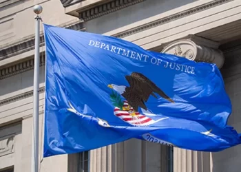 The U.S. Department of Justice flag flies outside the department’s building in Washington, D.C. (Photo: U.S. Department of Justice)