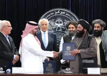 Zalmay Khalilzad looks on as a Saudi official shakes hands with senior Taliban figures during the signing of the Kashk-Tirpul agreement in Kabul. (Photo credit: Social Media)