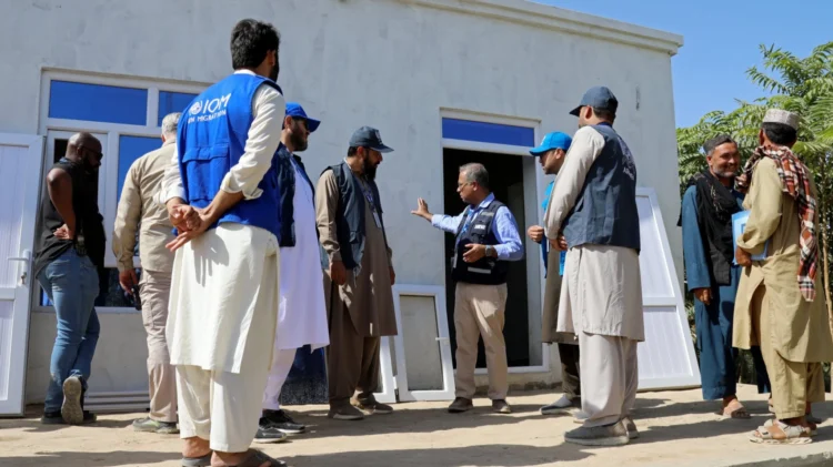 People gather in front of a house in Kunduz as local projects support livelihoods and create new economic opportunities. (Photo credit: UNDP)