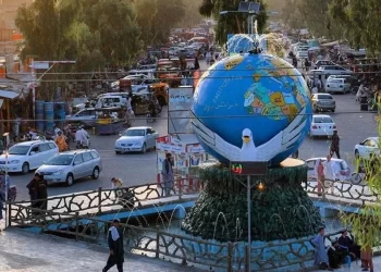 Traffic moves past a globe monument in Lashkargah, capital of Helmand province, where a woman was recently detained for secretly teaching girls. (Photo credit: Social Media)