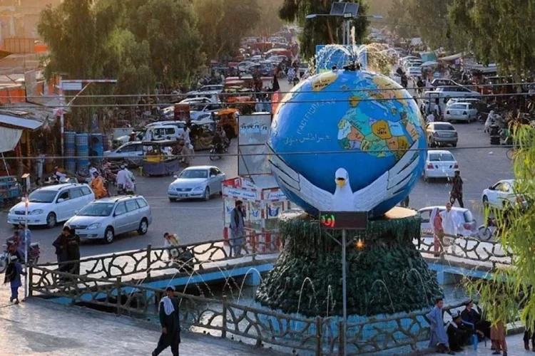 Traffic moves past a globe monument in Lashkargah, capital of Helmand province, where a woman was recently detained for secretly teaching girls. (Photo credit: Social Media)