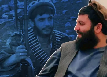 Mullah Hafiz, the Taliban governor of Farah, seen smiling beside an old photo of him as a young fighter in Badakhshan. (Photo credit: Social Media)