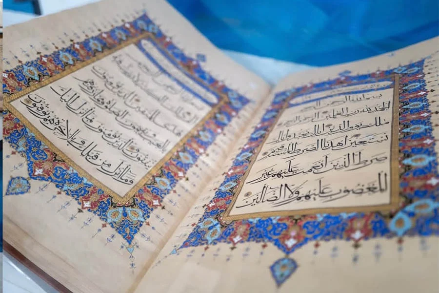 Illuminated Quran pages featuring traditional tazhib artwork are displayed at Naiko Arts in Herat. (Photo credit: Exclusive)