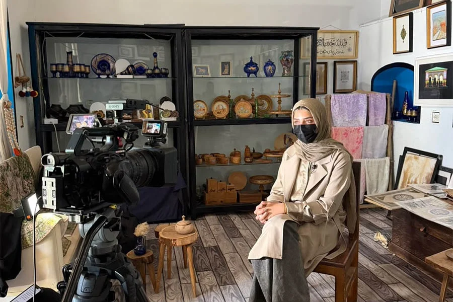 A woman is filmed for an interview at Naiko Arts, an art and cultural institute in Herat. (Photo credit: Exclusive)