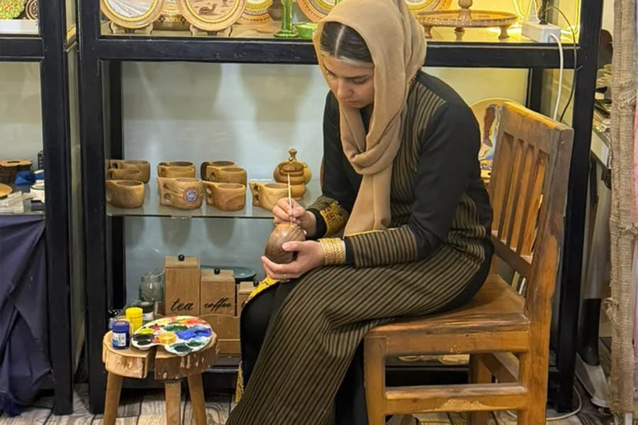A woman hand-paints a wooden craft at Naiko Arts, where women in Herat learn traditional art skills. (Photo credit: Exclusive)