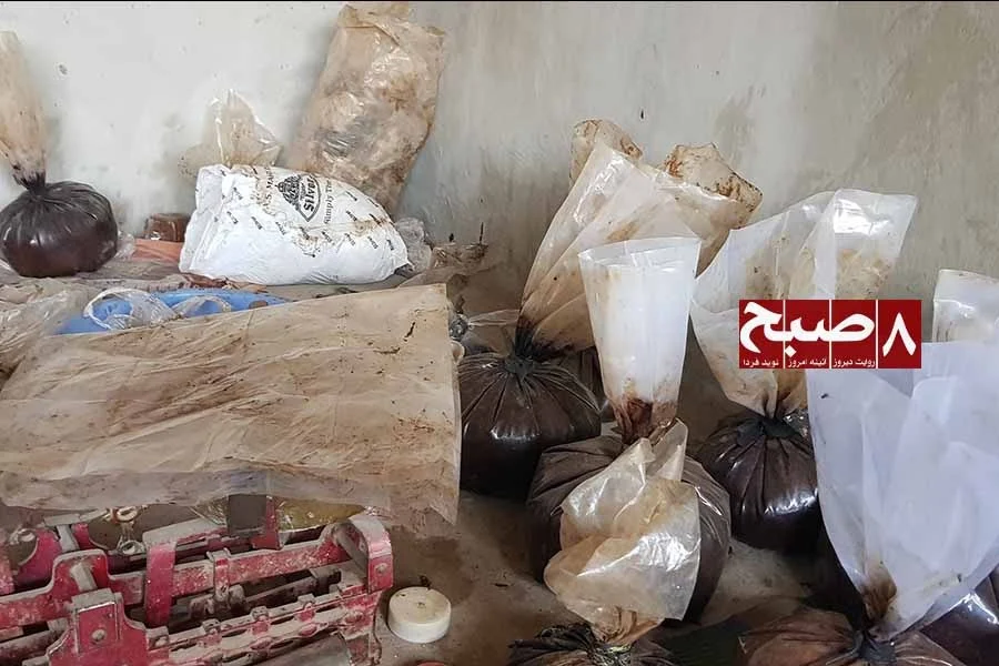 Bags of raw opium resin sit beside a red weighing scale inside a storage room as reports point to a thriving opium trade in Helmand. (Photo credit: 8am.media)