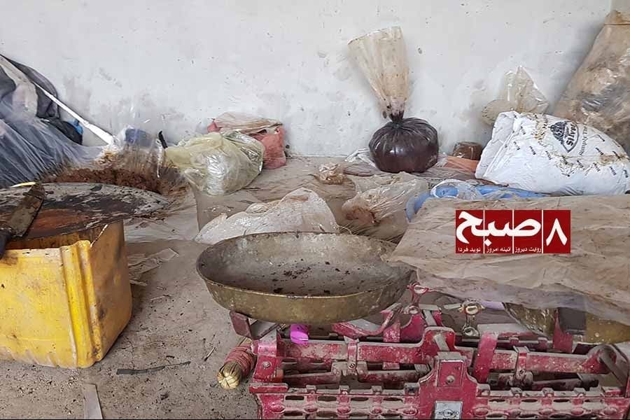 A red weighing scale with a brass pan sits in a storage room among plastic bags of opium resin as reports point to a thriving opium trade in Helmand. (Photo credit: 8am.media)