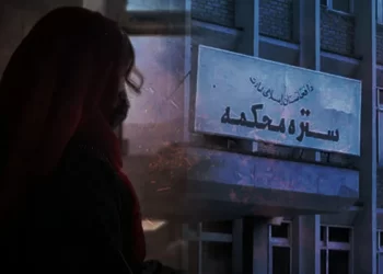 A woman looks toward the Taliban's Supreme Court building, where many women say their divorce requests have been rejected despite evidence of domestic violence. (Photo credit: Rukhshana + NUG)