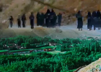 Taliban fighters patrol a hillside path overlooking a green valley in Paryan district, Panjshir province, where schoolgirls say they face daily harassment at checkpoints. (Photo credit: Exclusive + Social Media)