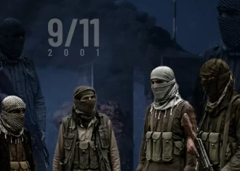 Masked militants stand before a smoke-filled backdrop marking the 25th anniversary of the September 11 attacks. (Photo credit: Reuters + AI)