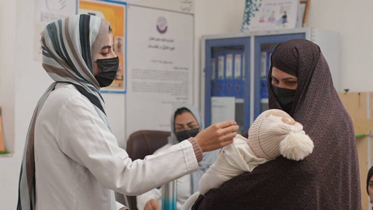 A woman with her child at a health center; female healthcare workers play an important role in providing healthcare services to families in Afghanistan. (Photo: UNFPA)