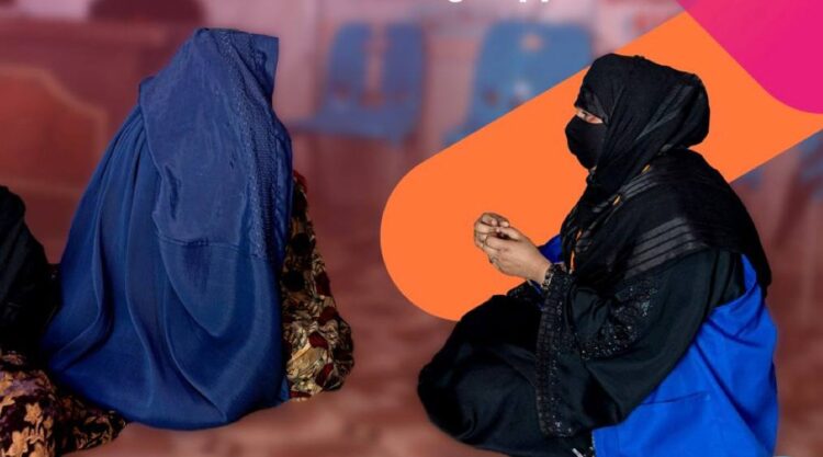 Female aid workers speak with Afghan women during a humanitarian assistance activity in Afghanistan. (Photo: UN Women)