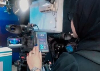 A woman operates a professional video camera during a filming or media production session (Photo: Exclusive)