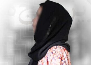 A woman wearing a black headscarf and a patterned shirt is shown in profile (Photo: Exclusive)