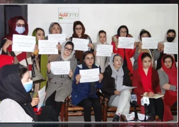 Women activists hold handwritten signs demanding the right to work and education during a press conference in Afghanistan. (Photo credit: Exclusive)