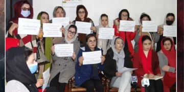 Women activists hold handwritten signs demanding the right to work and education during a press conference in Afghanistan. (Photo credit: Exclusive)