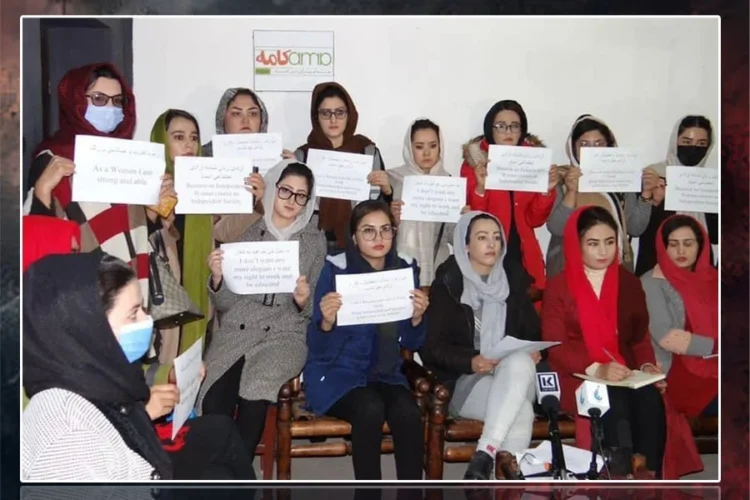 Women activists hold handwritten signs demanding the right to work and education during a press conference in Afghanistan. (Photo credit: Exclusive)