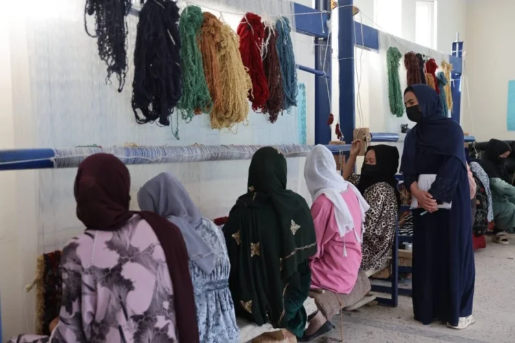 Women participate in a carpet-weaving training programme in Bamyan Province supported by the United Nations High Commissioner for Refugees (UNHCR). (Photo credit: UNHCR)