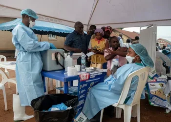 Healthcare workers wearing protective equipment assist patients at an Ebola treatment and screening center in the Democratic Republic of Congo (Photo: Reuters)