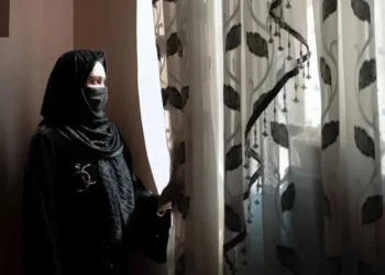 A girl stands by a window, looking outside, amid concerns over child marriage and restrictions on girls' rights and education in Afghanistan. (Photo credit: UNICEF)