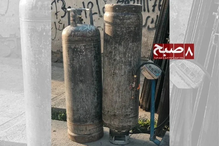Two worn liquefied gas cylinders stand on a Kabul street as residents complain about rising LPG prices and uneven market rates. (Photo credit: 8am.media)