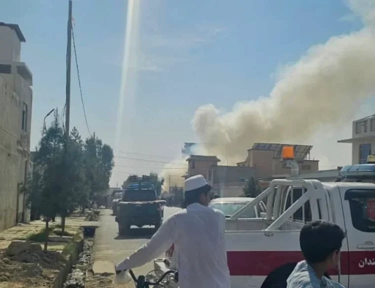 Smoke is seen rising from a distant view as police vehicles are parked (Photo: Exclusive)
