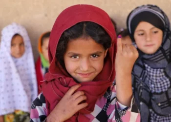 A little Afghan girl smiling at the camera and showing her finger marked for Polio vaccination (Photo: @PolioFreeAfghan)