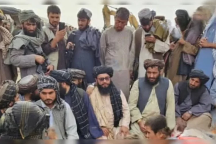 A group of miners and Taliban officials gather after miners trapped under rubble in Takhar were rescued. (Photo credit: @bnadari1)