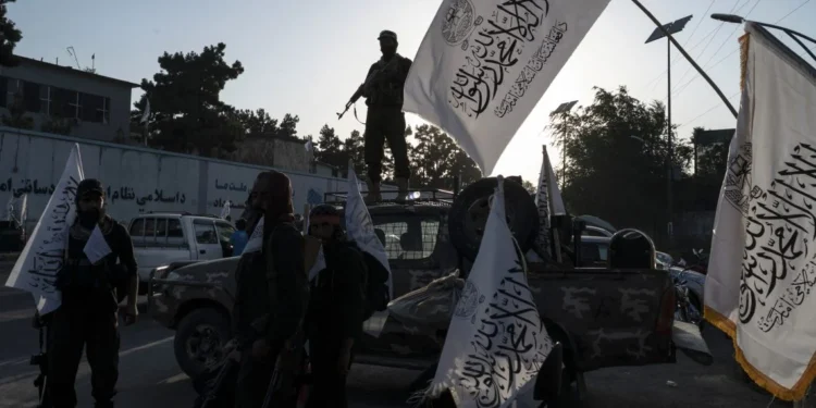 Taliban representatives stand near their flags during an official gathering amid scrutiny over Switzerland’s decision to host a Taliban delegation in Geneva. (Photo credit: AFP)