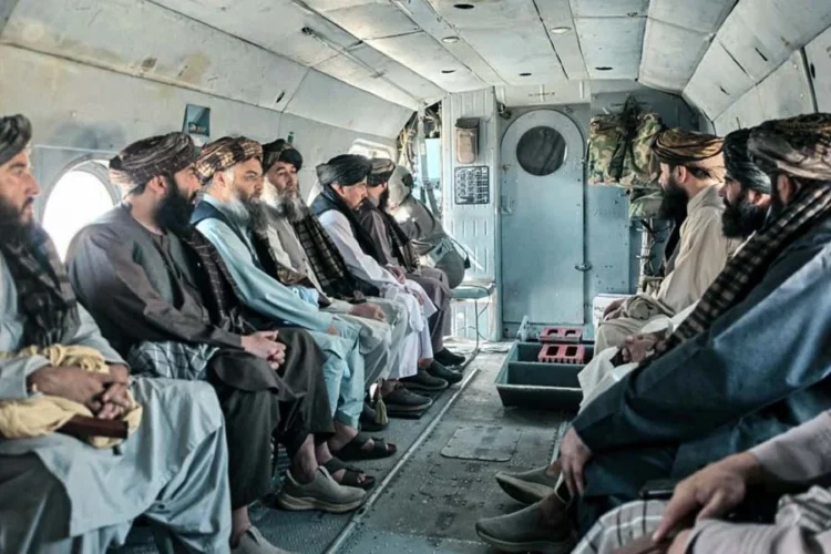 Men in turbans sit inside a helicopter cabin during a Taliban official's tour of northern provinces amid rising anti-Taliban attacks. (Photo credit: didpress)
