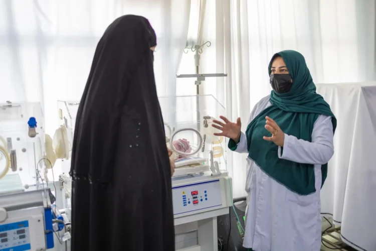 A female doctor explains health information to a woman as UNICEF supports essential healthcare services in Afghanistan. (Photo credit: @UNICEFAfg)