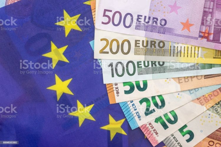 euro bills on the european flag background.