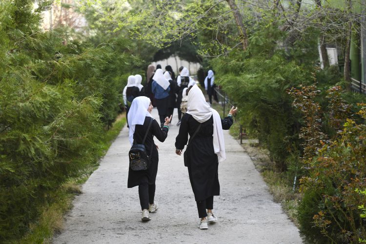 CAPTION ADDITION - updated information - 
Girls arrive at their school in Kabul on March 23, 2022.. The Taliban ordered girls' secondary schools in Afghanistan to shut on March 23 just hours after they reopened, an official confirmed, sparking confusion and heartbreak over the policy reversal by the hardline Islamist group. (Photo by Ahmad SAHEL ARMAN / AFP) / CAPTION ADDITION - CAPTION ADDITION